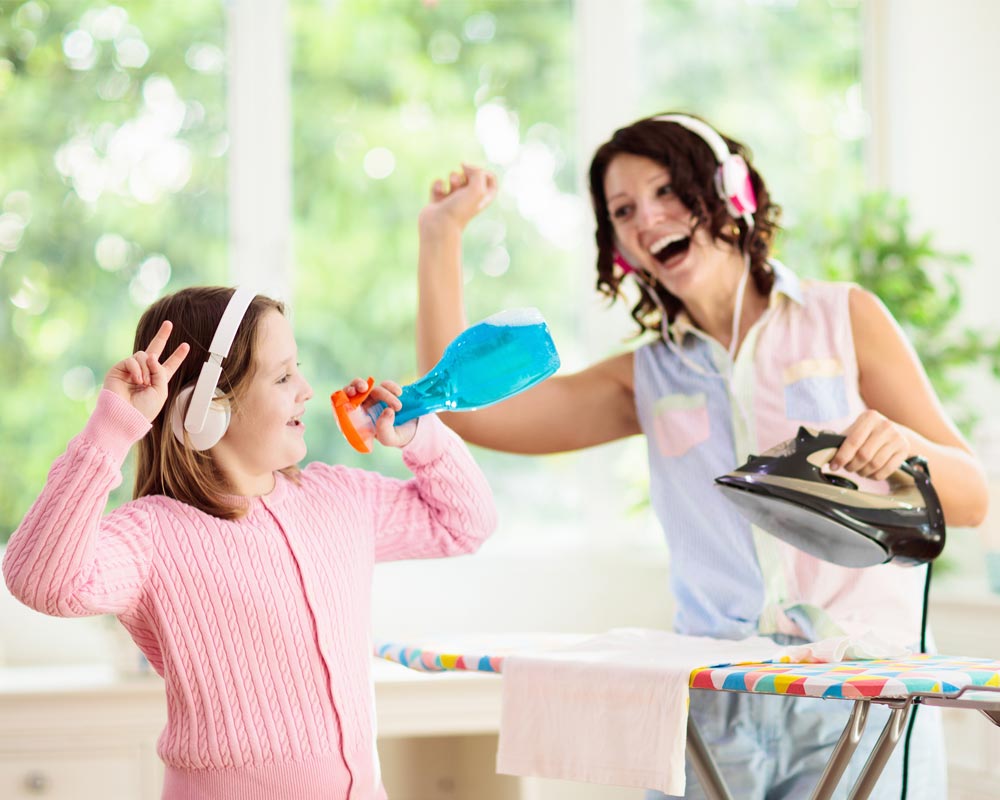 Mother and daughter enjoy cleaning and singing