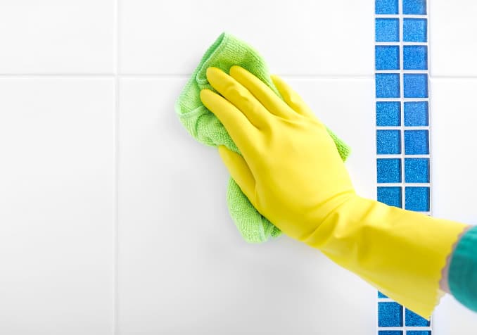 Hand with Cleaning Gloves Bathroom Grout