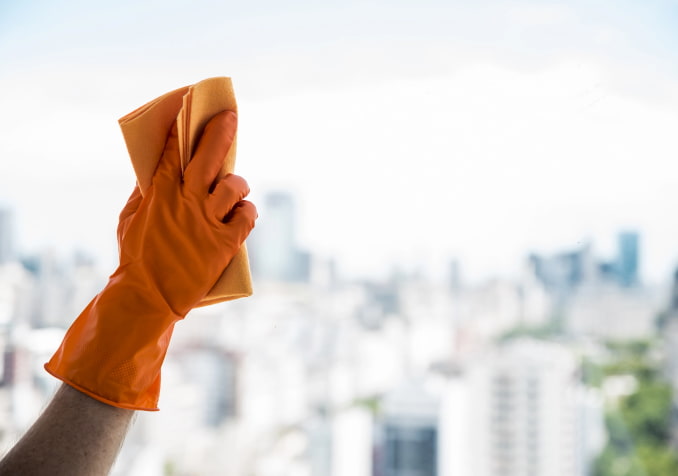 Hand with Microfiber Towel Cleaning Window