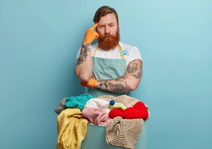 Man with Tattoos doing Laundry
