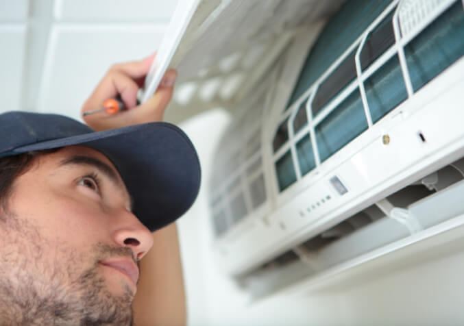 Electrodry Technician Inspecting Air Conditioner