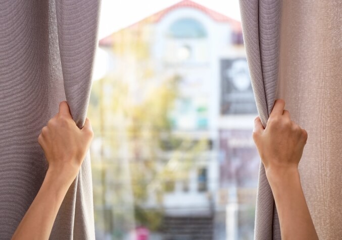 Opening Curtains to Let Sunshine In