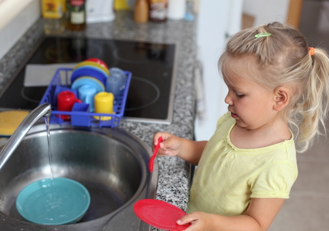 Child Washing Her Toys