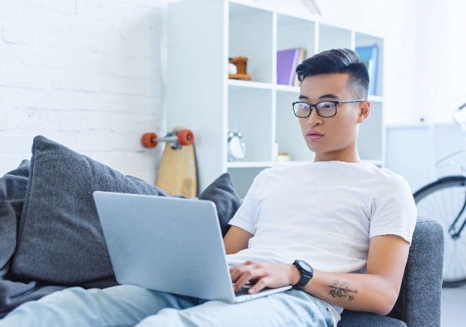 Man using Laptop while sitting