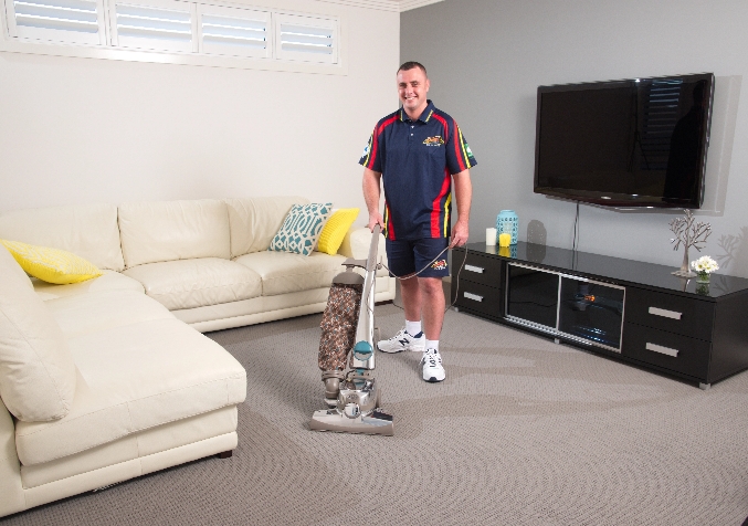 Electrodry Technician Vacuuming Carpet in Living Room