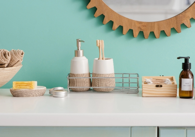 Bathroom items organized on top of a marble surfaced cabinet