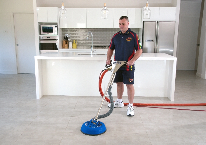 Electrodry Technician buffing tiled floor in the kitchen