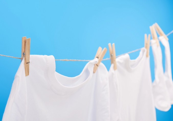 White Shirts Attached to Clothesline using Wooden Clotherspin