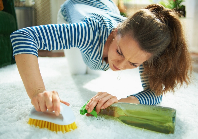 Woman eagerly scrubs and cleans the carpet