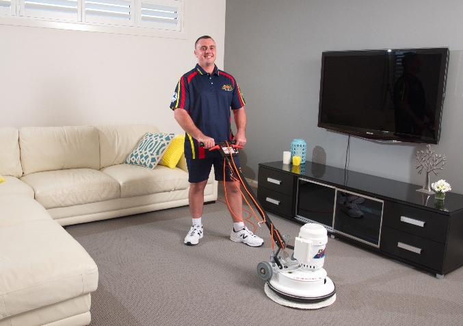 Electrodry Technician buffs carpet in the living room