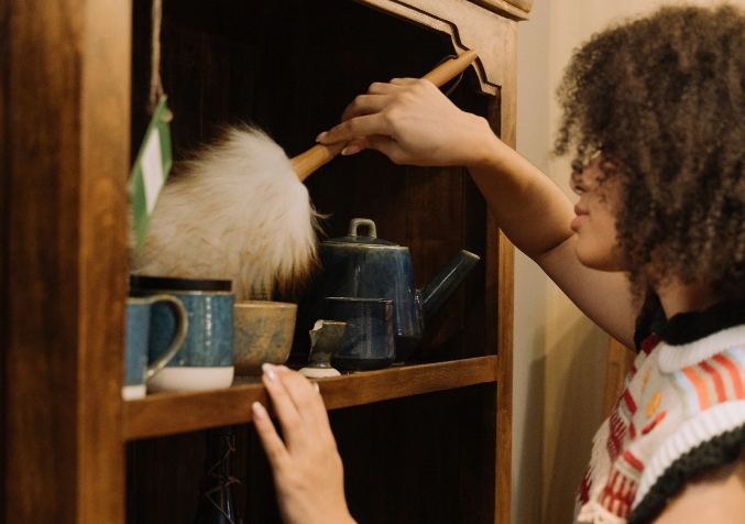 Woman Dusting Shelves
