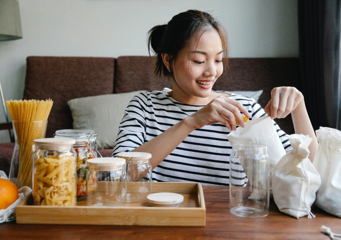 Woman Repacking Store Bought Pasta from Recyclable Bags