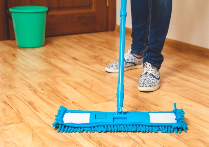 Woman Wiping Wood Floors with Microfiber Mop