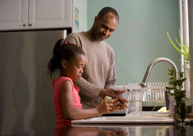 little girl helping her dad with chores