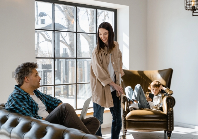 parents looking  at kid using a phone