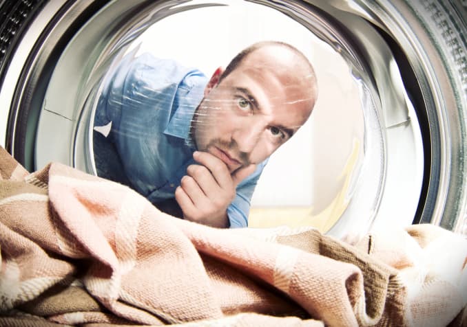 Electrodry Blog - Man looking into washing machine